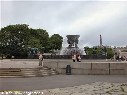 Vigeland fountain with bronze statues and monolith in background, Oslo