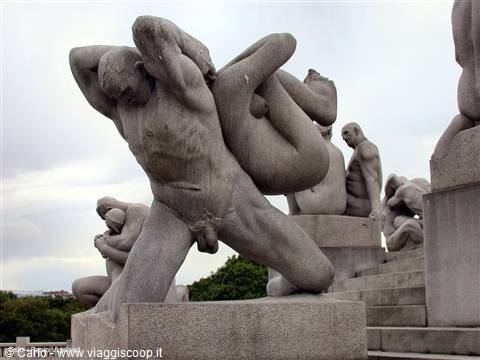 Granite Vigeland statue: a man lifts a baby among other sculptures