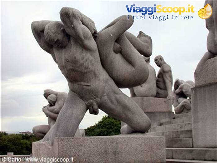 Granite Vigeland statue: a man lifts a baby among other sculptures