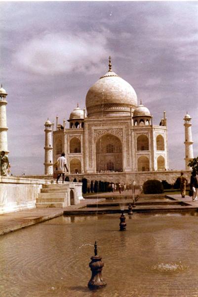 Visitors at the Taj Mahal in Agra, marble dome above the water pools