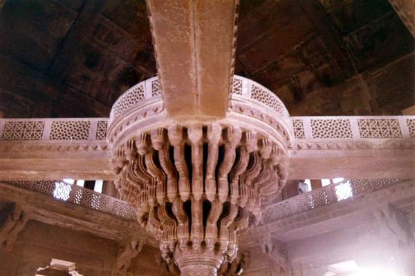 Carved central pillar of Diwan-i-Khas at Fatehpur Sikri, warm light on sandstone