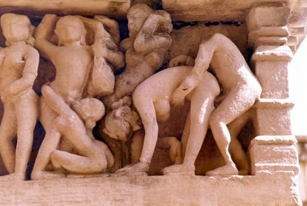 Sandstone carvings of intertwined human figures on a Khajuraho temple