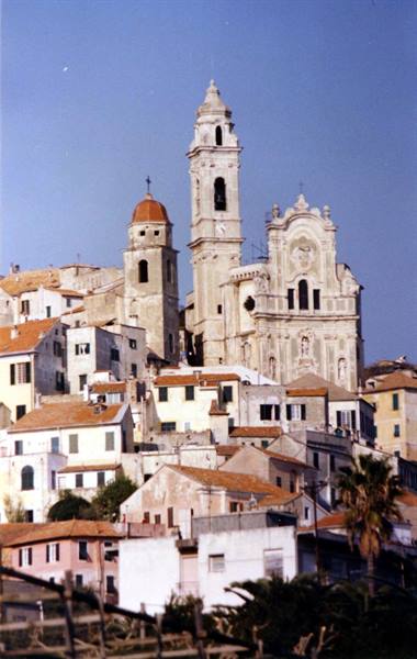 Baroque church and bell tower above colorful houses in Cervo, Liguria