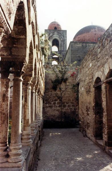 Stone colonnaded cloister and red domes of San Giovanni degli Eremiti, Palermo