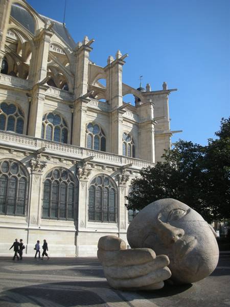 Stone sculpture of a head and hand before Saint-Eustache church, Paris