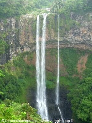 Chamarel Falls: three water streams plunge down moss-covered basalt cliffs