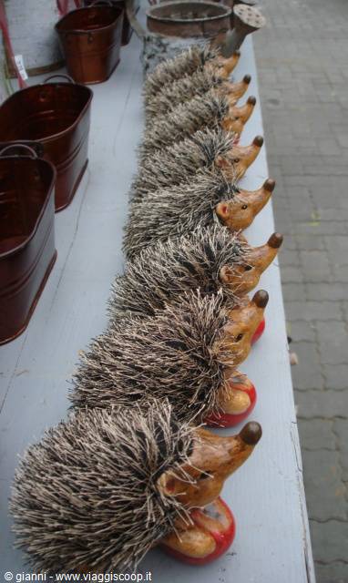 Row of bristle and wood hedgehog figurines on a market stall