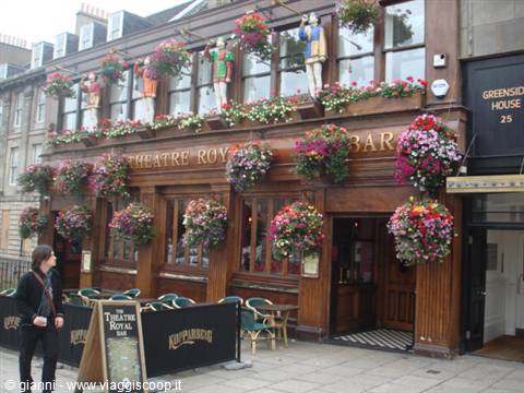 Wooden facade of the Theatre Royal Bar in Edinburgh, decorated with hanging flowers