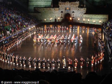 Military tattoo with bagpipes at Edinburgh Castle, torches and crowd