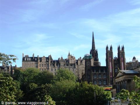 Edinburgh: gothic spires and dark stone towers rising above green trees