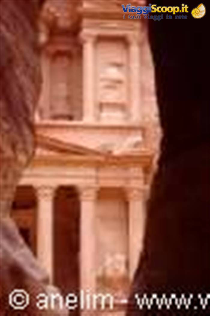 The Treasury facade carved in pink rock at Petra seen from the Siq