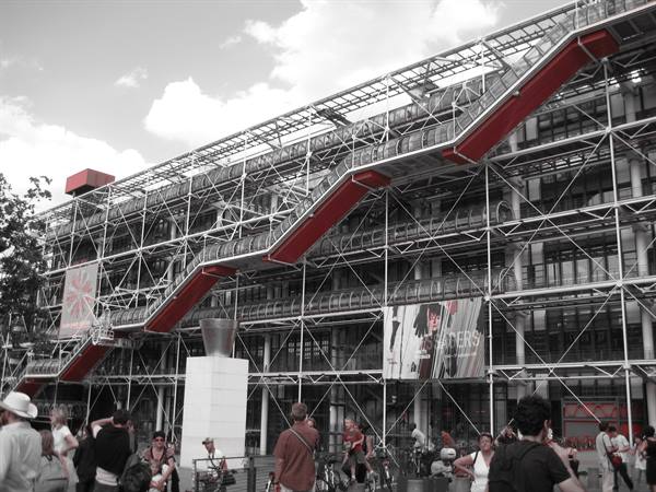 Centre Pompidou: red external escalator on steel framework, tourists in the square