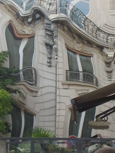 Art nouveau facade with wrought iron balconies and carved stone decorations