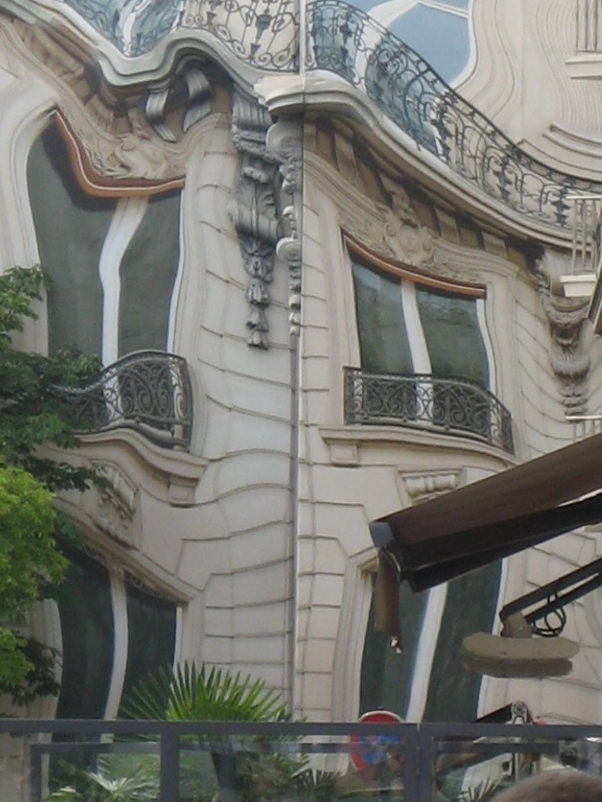 Art nouveau facade with wrought iron balconies and carved stone decorations