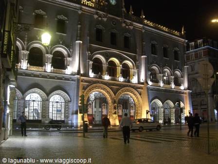Rossio railway station in Lisbon lit up at night with Manueline arches
