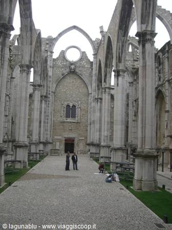 Visitors among stone arches of the roofless Convento do Carmo