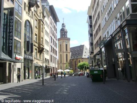 Pedestrians on a car-free street before Frankfurt's Katharinenkirche, baroque tower