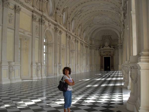 Woman with bag in the Galleria Grande at Venaria, checkered floor and side light