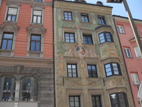 Frescoed facades with oriel windows in Innsbruck under daylight