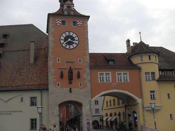 Medieval stone clock tower and arched city gate in Regensburg