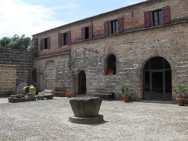 Inner courtyard of the Borgia castle with ancient stone well in the center
