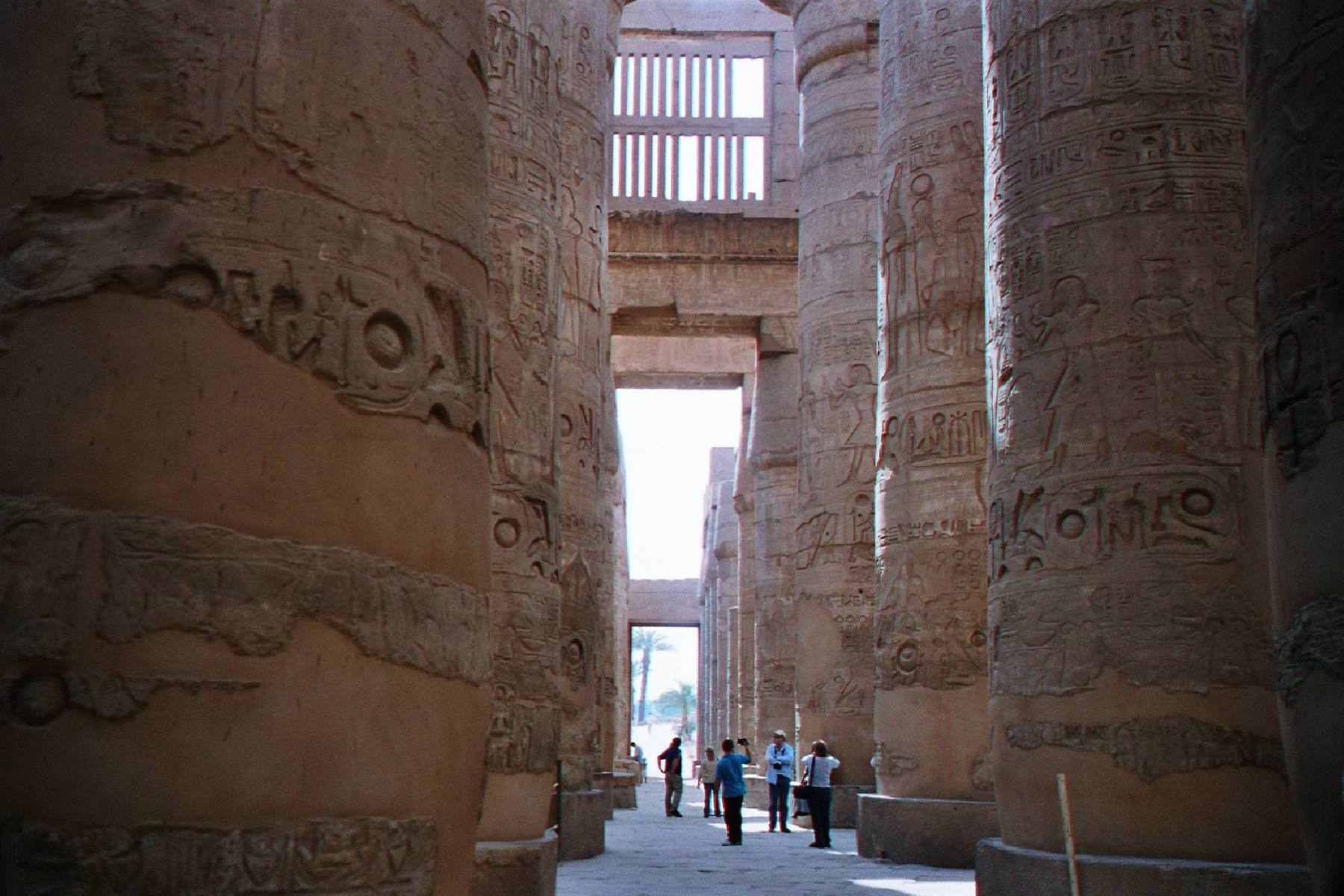 Tourists among the giant columns of Karnak temple, natural light