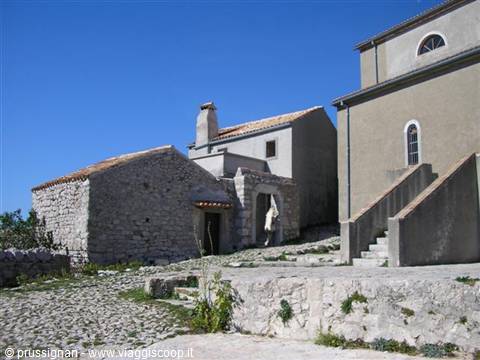 Stone houses with tiled roofs and outdoor staircase in the village of Lubenice