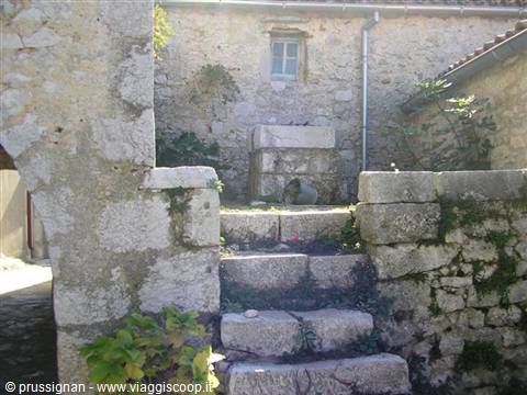 Old stone fountain with steps between dry stone walls
