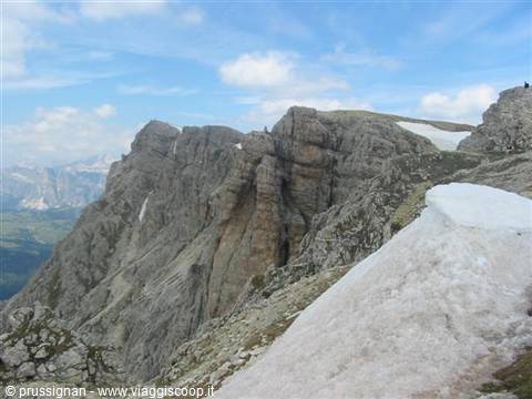 Limestone cliffs and leftover snow on a Dolomites ridge