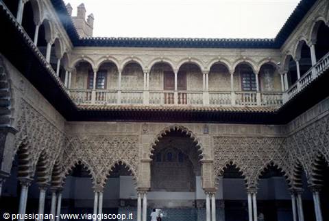 Mudejar courtyard of the Real Alcazar of Seville: stuccoed arches, twin gallery