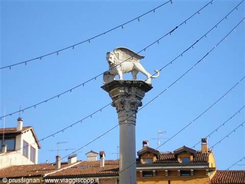 Stone column with the winged Lion of Saint Mark in Venice, blue sky