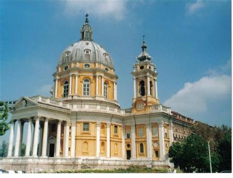 Basilica di Superga in Turin, yellow facade with dome and bell tower under blue sky