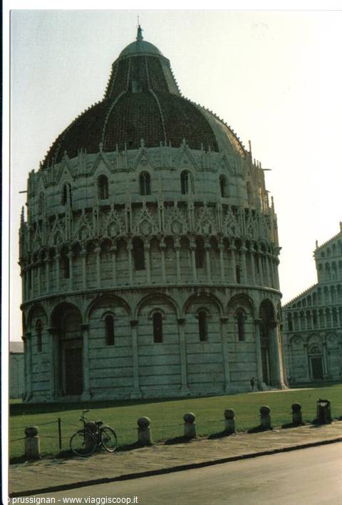 Pisa Baptistery in white marble, bicycle parked along the sidewalk