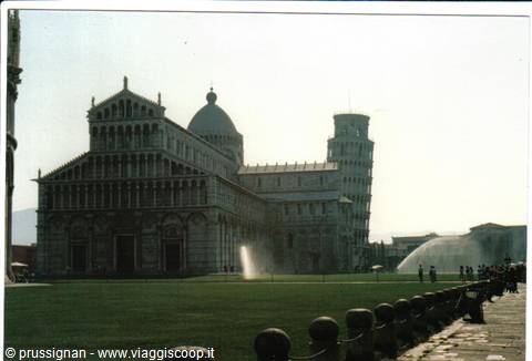 Pisa Cathedral and leaning tower seen from the lawn, fountains spraying