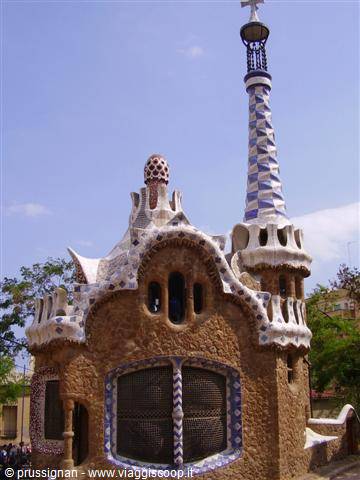 Stone pavilion with mosaics and decorated tower at Parc Güell, Barcelona
