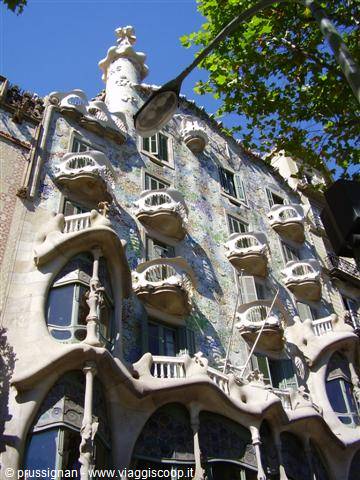 Wavy facade of Casa Batlló in Barcelona, wrought iron balconies and trencadís
