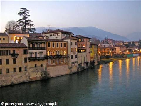 Bassano del Grappa, colored houses along the Brenta river at dusk