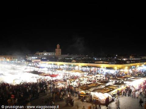 Jemaa el-Fna square at night: crowd among illuminated market stalls