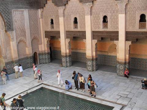 Tourists around the reflecting pool in Ben Youssef Madrasa courtyard