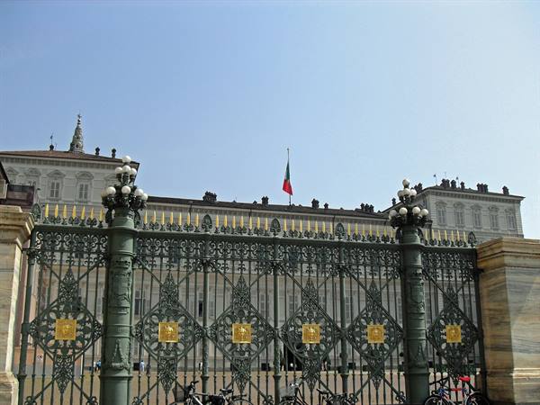 Green wrought-iron gate with golden crests in front of Palazzo Reale, Turin