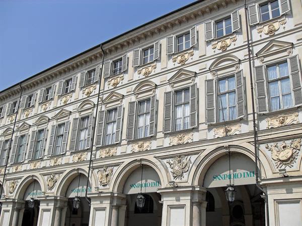 Baroque facade with arched porticoes and stucco decorations, Piazza San Carlo