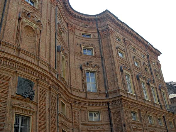 Curved red-brick facade of Palazzo Carignano in Turin, daylight