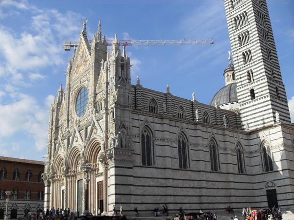 Siena Cathedral, Gothic marble facade with striped bell tower and tourists