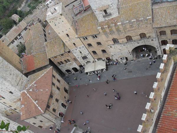 Aerial view of the square with tourists among San Gimignano's medieval towers