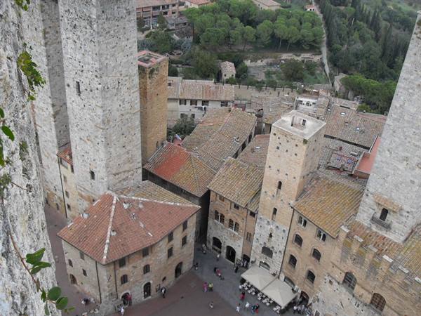 San Gimignano: medieval stone towers above terracotta rooftops and a busy square