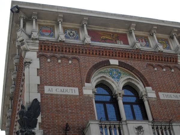 Brick facade of Thiene building, mosaics with coats of arms and winged lion