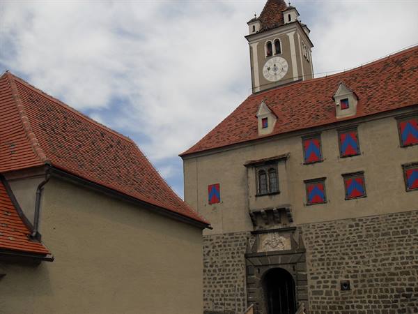 Riegersburg castle: clock tower, red tiled roofs and stone walls