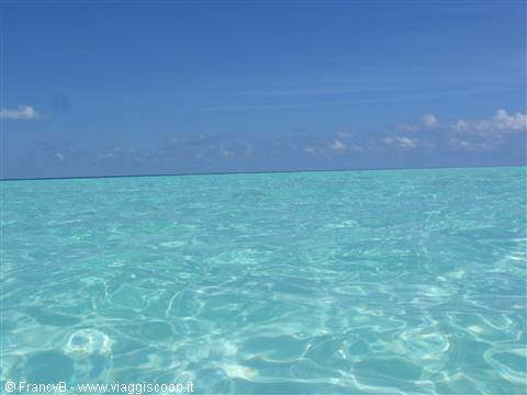 Clear turquoise water with light reflections under a blue sky