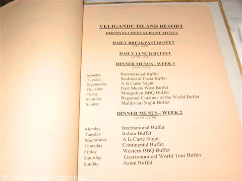 Printed dinner menu of Veligandu Island Resort open on its page
