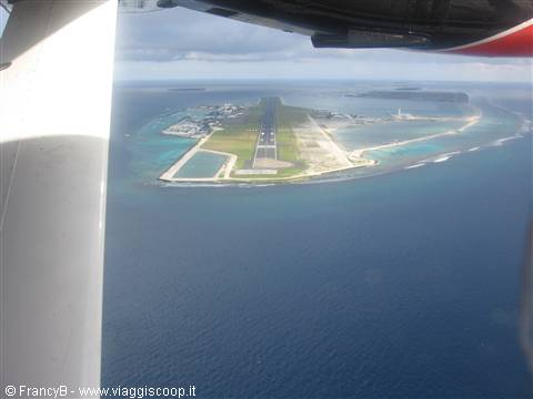 From the plane, the runway crossing the atoll surrounded by turquoise lagoon